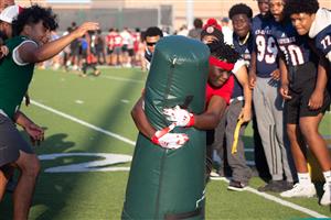 Langham Creek HS sophomore Miles Burrell participates in a tackling drill as CFISD football players look on at Camp Courage.
